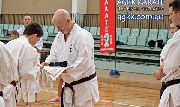 Student being presented a Black Belt